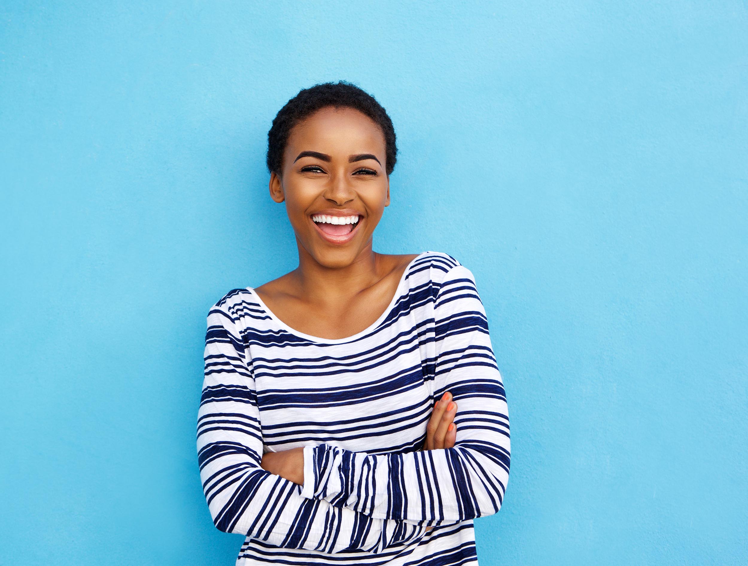 happy young black woman laughing after dental services