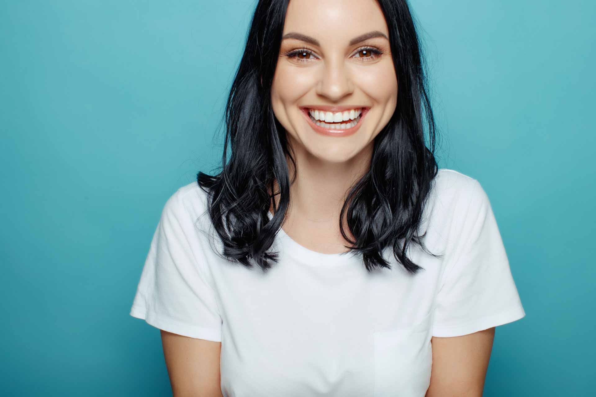Beautiful woman proudly smiling after veneers appointment